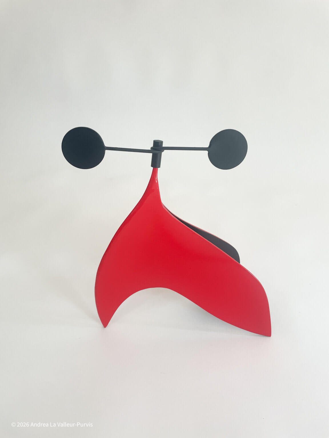 abstract red metal sculpture with black interior, kinetic top by Sculptor Andrea La Valleur-Purvis